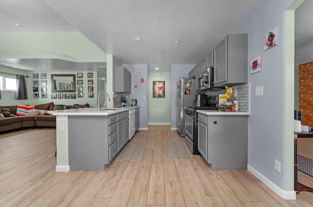 3673 N Denali Ave, Fresno, CA 93727 - kitchen with stainless steel appliances, gray cabinetry, light countertops, light wood-style flooring, and recessed lighting