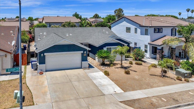 3673 N Denali Ave, Fresno, CA 93727 - view of front of house with a garage, a residential view, concrete driveway, and stucco siding