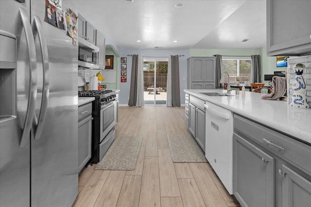 3673 N Denali Ave, Fresno, CA 93727 - kitchen featuring stainless steel appliances, gray cabinets, plenty of natural light, light wood-style floors, and recessed lighting