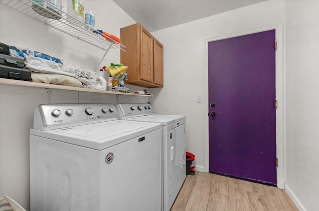 3673 N Denali Ave, Fresno, CA 93727 - laundry area featuring independent washer and dryer, light wood-style floors, and cabinet space
