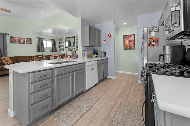 3673 N Denali Ave, Fresno, CA 93727 - kitchen featuring dishwasher, gray cabinetry, gas range oven, stainless steel microwave, and open floor plan