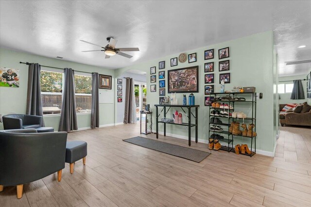 3673 N Denali Ave, Fresno, CA 93727 - living room with arched walkways, a ceiling fan, and wood finished floors