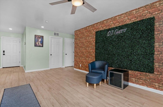 3673 N Denali Ave, Fresno, CA 93727 - living area with brick wall, wood finished floors, ceiling fan, and recessed lighting