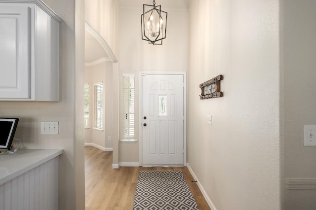 10223 N Price Ave, Fresno, CA 93730 - foyer entrance with a chandelier, light wood-style floors, and arched walkways