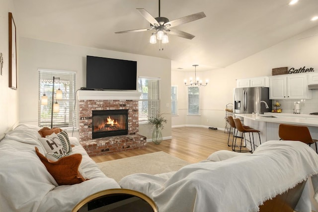 10223 N Price Ave, Fresno, CA 93730 - living area with light wood-style flooring, a chandelier, plenty of natural light, a ceiling fan, and lofted ceiling