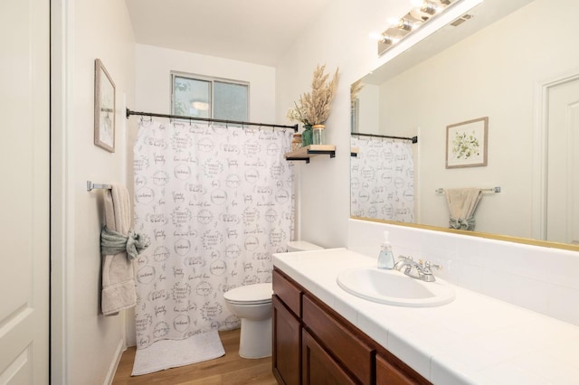 10223 N Price Ave, Fresno, CA 93730 - full bath with wood finished floors, vanity, and a shower with shower curtain