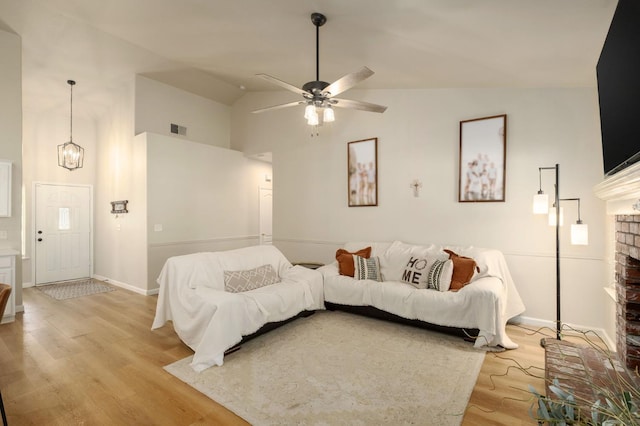 10223 N Price Ave, Fresno, CA 93730 - living area featuring light wood finished floors, a fireplace, high vaulted ceiling, and ceiling fan