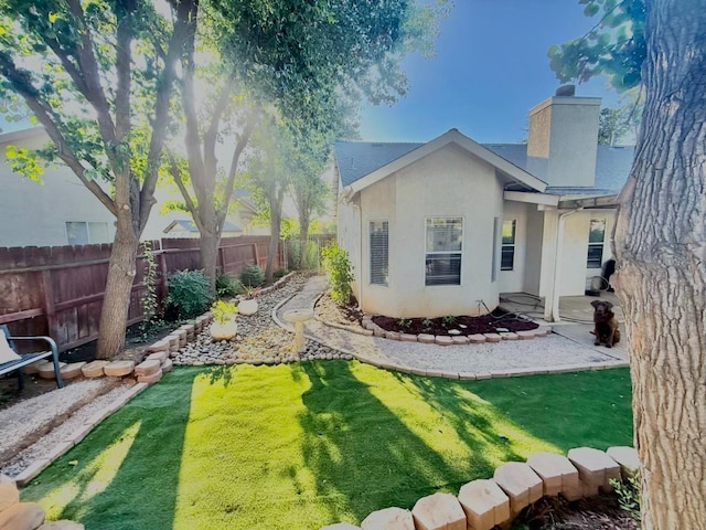 10223 N Price Ave, Fresno, CA 93730 - rear view of property with a chimney and stucco siding