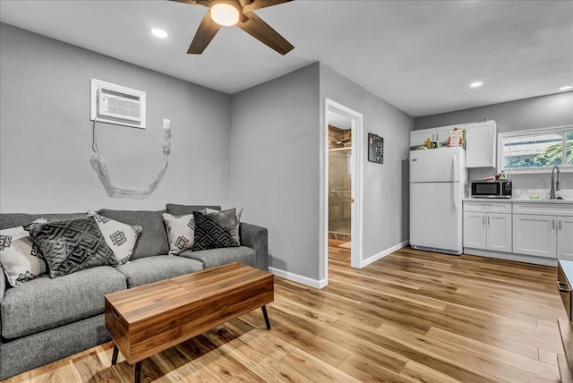 1408 S Hope Ave, Reedley, CA 93654 - living room with a ceiling fan, a wall mounted air conditioner, light wood-type flooring, and recessed lighting