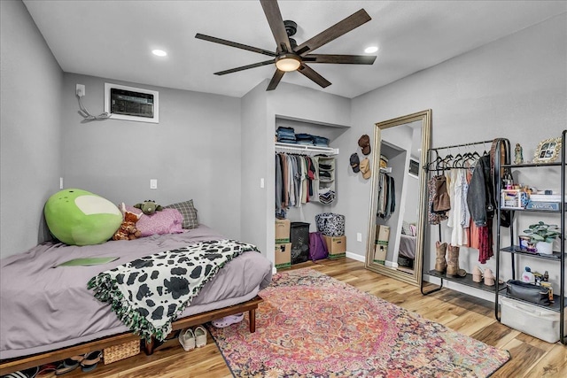 1408 S Hope Ave, Reedley, CA 93654 - bedroom with wood finished floors, a wall mounted AC, recessed lighting, ceiling fan, and a closet