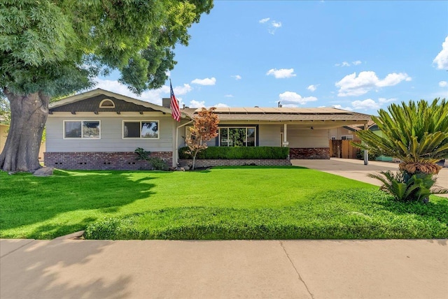 1408 S Hope Ave, Reedley, CA 93654 - ranch-style home featuring solar panels, a front yard, and brick siding