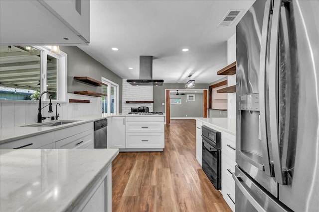 1408 S Hope Ave, Reedley, CA 93654 - kitchen with appliances with stainless steel finishes, open shelves, island exhaust hood, light wood-type flooring, and white cabinetry