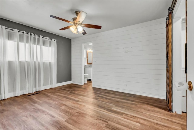 1408 S Hope Ave, Reedley, CA 93654 - spare room featuring wood finished floors, ceiling fan, and wood walls