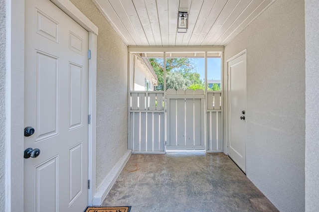 927 W Pico Ave, Fresno, CA 93705 - doorway to outside featuring a textured wall and wood ceiling