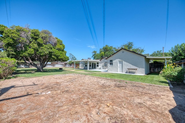 927 W Pico Ave, Fresno, CA 93705 - back of property featuring a fenced backyard, stucco siding, and a patio