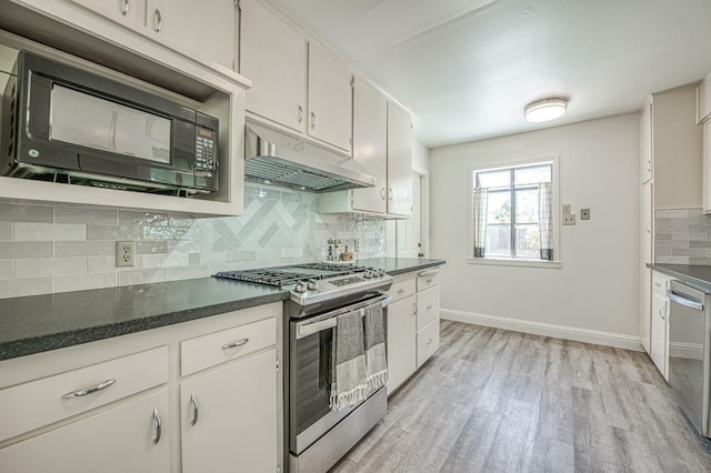 927 W Pico Ave, Fresno, CA 93705 - kitchen with appliances with stainless steel finishes, under cabinet range hood, light wood-style floors, and dark countertops