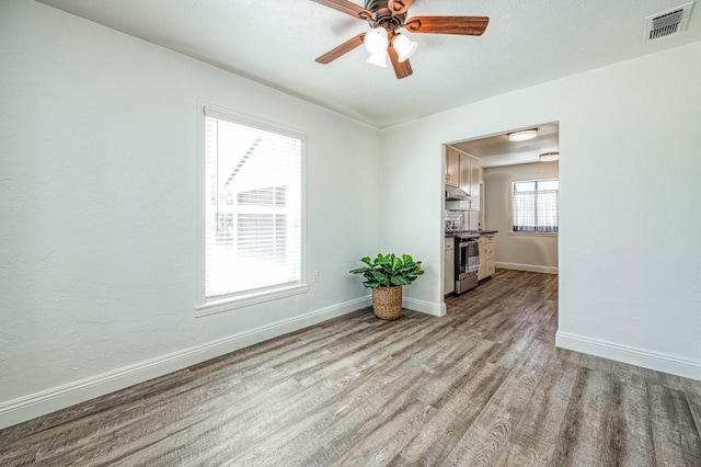 927 W Pico Ave, Fresno, CA 93705 - unfurnished living room with wood finished floors and a ceiling fan