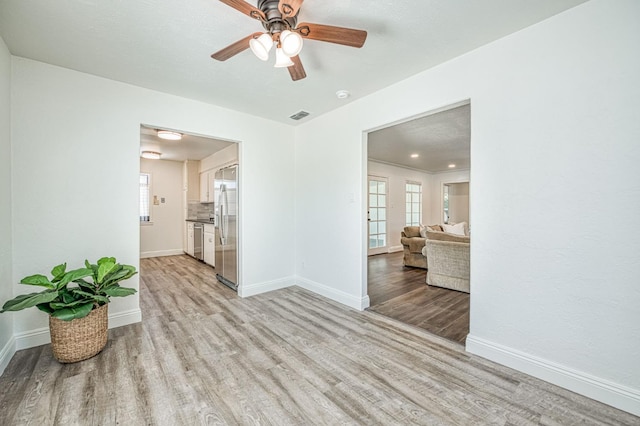 927 W Pico Ave, Fresno, CA 93705 - empty room with light wood finished floors and a ceiling fan