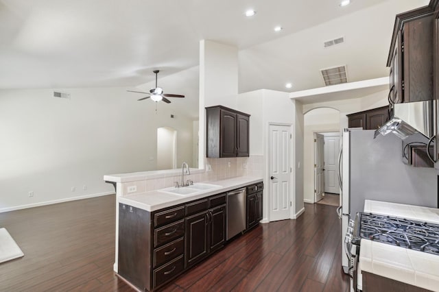 1158 E Hogan Ave, Fresno, CA 93730 - kitchen featuring arched walkways, stainless steel appliances, dark brown cabinetry, recessed lighting, and lofted ceiling