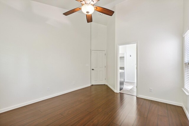 1158 E Hogan Ave, Fresno, CA 93730 - empty room featuring a ceiling fan, a high ceiling, and dark wood-style floors