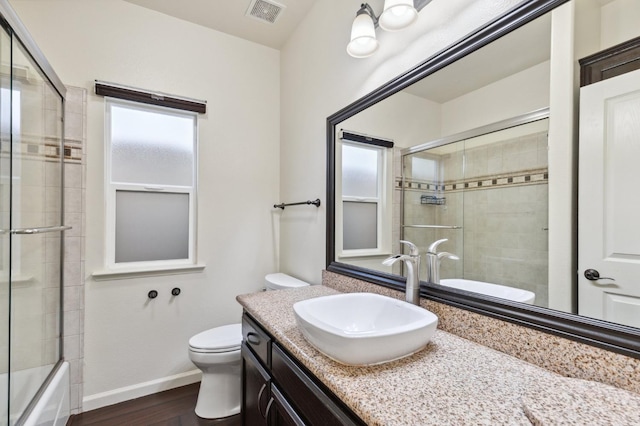 1158 E Hogan Ave, Fresno, CA 93730 - bathroom with wood finished floors, vanity, and combined bath / shower with glass door