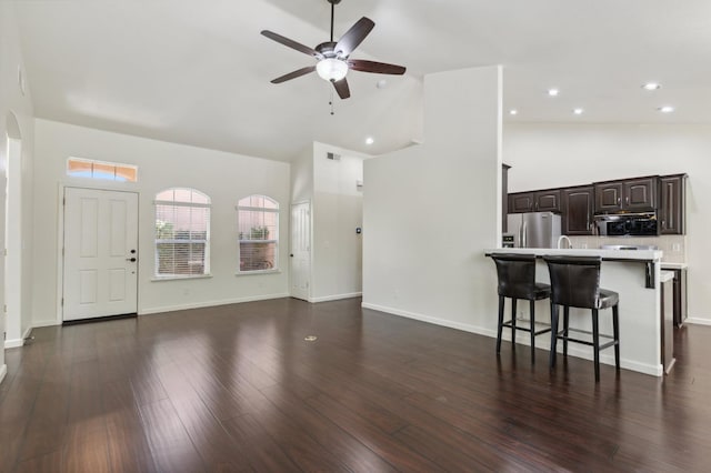 1158 E Hogan Ave, Fresno, CA 93730 - unfurnished living room with high vaulted ceiling, a ceiling fan, dark wood-style floors, recessed lighting, and arched walkways