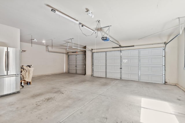 1158 E Hogan Ave, Fresno, CA 93730 - garage featuring freestanding refrigerator and a garage door opener