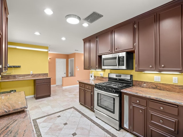 3110 N Del Mar Ave, Fresno, CA 93704 - kitchen with appliances with stainless steel finishes, recessed lighting, light tile patterned flooring, dark brown cabinets, and light stone countertops