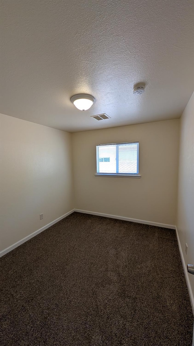 1405 N Lake St, Madera, CA 93638 - unfurnished room featuring dark colored carpet, a smoke detector, and a textured ceiling
