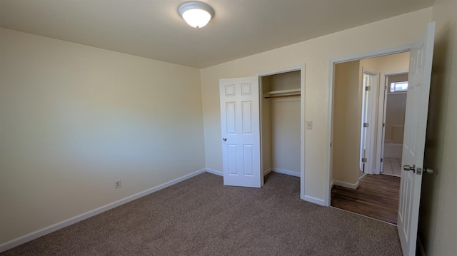 1405 N Lake St, Madera, CA 93638 - unfurnished bedroom with dark colored carpet and a closet