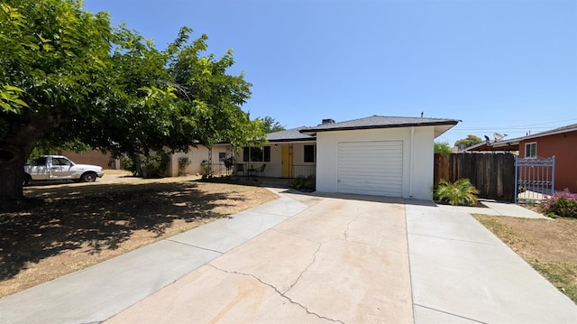 1405 N Lake St, Madera, CA 93638 - ranch-style home featuring a garage, driveway, and stucco siding