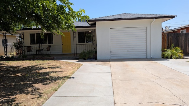 1405 N Lake St, Madera, CA 93638 - ranch-style home with concrete driveway, an attached garage, and a porch