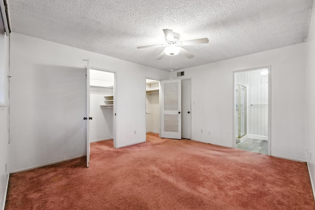 4909 N 7th St Unit S, Fresno, CA 93726 - unfurnished bedroom with carpet flooring, a textured ceiling, ensuite bathroom, and ceiling fan