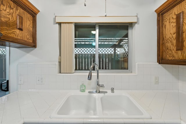4909 N 7th St Unit S, Fresno, CA 93726 - kitchen featuring backsplash and brown cabinets