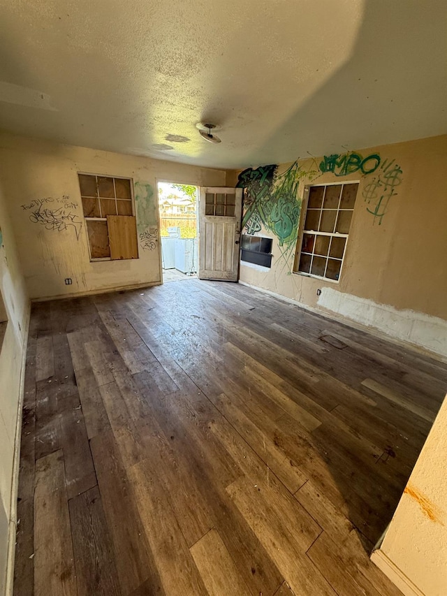 1020 N Ferger Ave, Fresno, CA 93728 - unfurnished living room featuring hardwood / wood-style floors and a textured ceiling