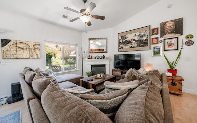 2148 N Ivanhoe Ave, Fresno, CA 93722 - living area with a glass covered fireplace, light wood-type flooring, and ceiling fan