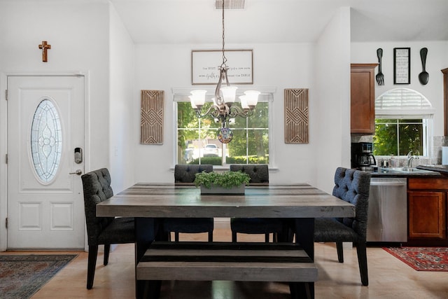 2148 N Ivanhoe Ave, Fresno, CA 93722 - dining space with a chandelier, light wood-style flooring, and healthy amount of natural light