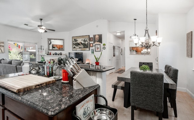 2148 N Ivanhoe Ave, Fresno, CA 93722 - kitchen with open floor plan, a ceiling fan, a chandelier, lofted ceiling, and dark stone countertops
