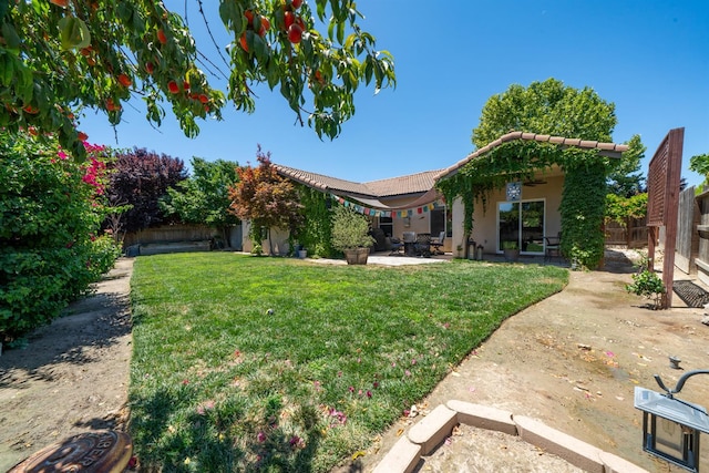 2148 N Ivanhoe Ave, Fresno, CA 93722 - fenced backyard with a patio