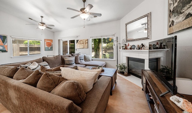2148 N Ivanhoe Ave, Fresno, CA 93722 - living room with plenty of natural light, light wood-style flooring, a glass covered fireplace, and a ceiling fan