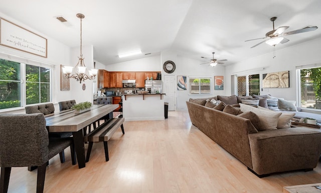 2148 N Ivanhoe Ave, Fresno, CA 93722 - living area with lofted ceiling, light wood-style flooring, a chandelier, and a ceiling fan