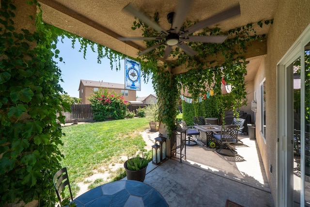 2148 N Ivanhoe Ave, Fresno, CA 93722 - fenced backyard with a ceiling fan, a patio, and outdoor dining area