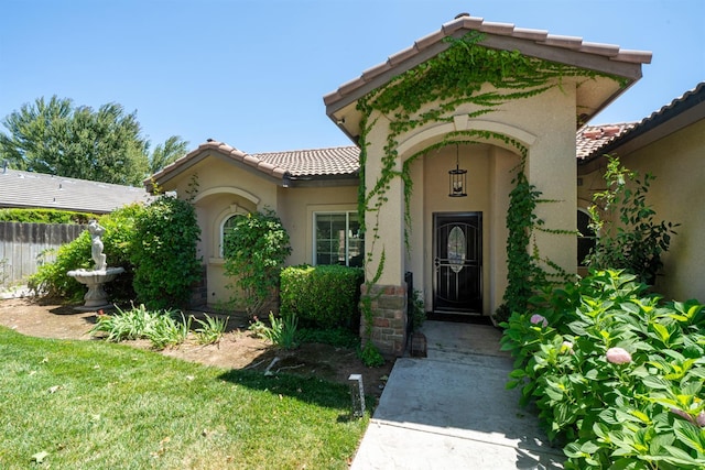 2148 N Ivanhoe Ave, Fresno, CA 93722 - property entrance with a tiled roof and stucco siding