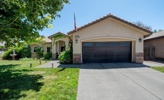 2148 N Ivanhoe Ave, Fresno, CA 93722 - mediterranean / spanish-style house featuring an attached garage, driveway, a front yard, and stucco siding