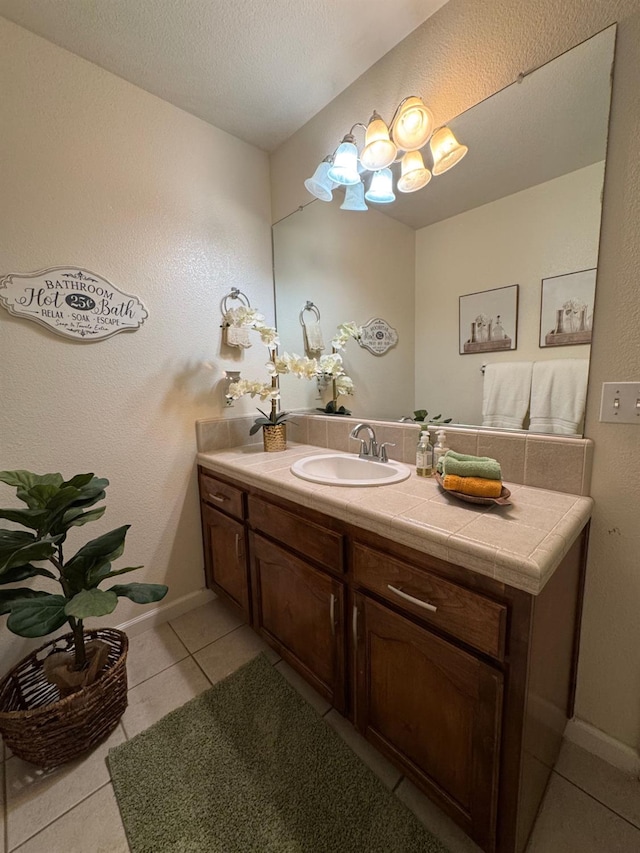 605 W Russell Ave, Visalia, CA 93277 - bathroom featuring tile patterned flooring, vanity, and a chandelier