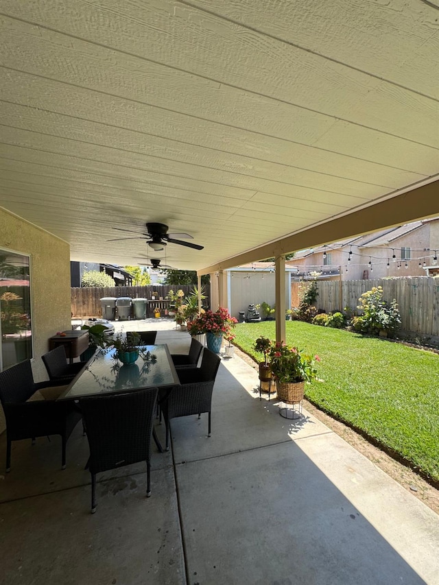605 W Russell Ave, Visalia, CA 93277 - fenced backyard featuring outdoor dining area, ceiling fan, and a patio area