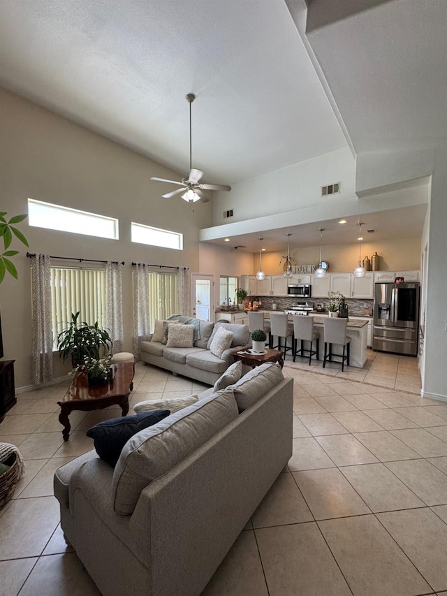 605 W Russell Ave, Visalia, CA 93277 - living area with light tile patterned flooring, ceiling fan, and a towering ceiling