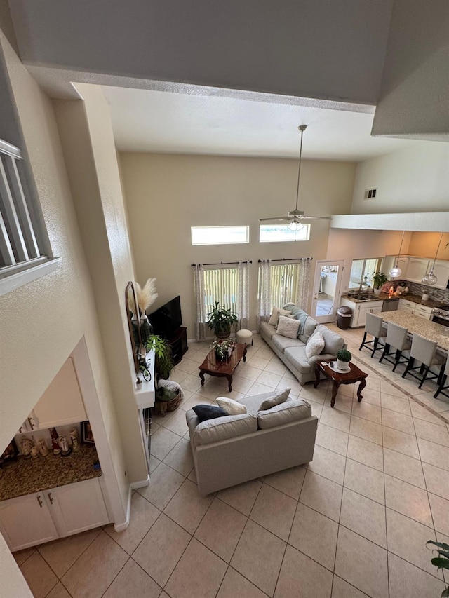 605 W Russell Ave, Visalia, CA 93277 - living room featuring a towering ceiling, light tile patterned flooring, and ceiling fan