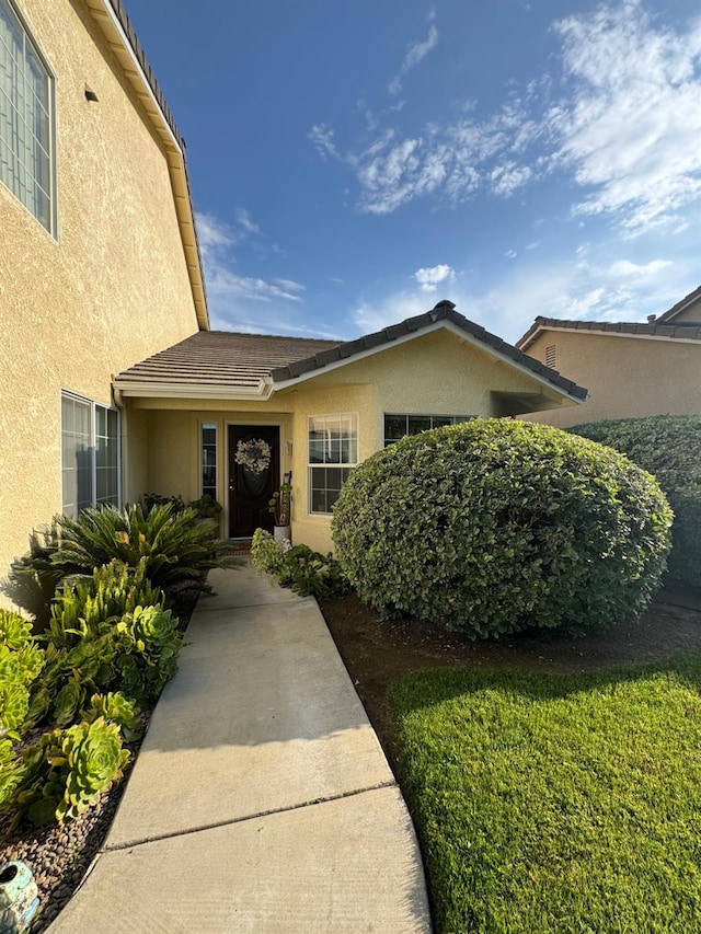 605 W Russell Ave, Visalia, CA 93277 - property entrance featuring stucco siding and a tile roof