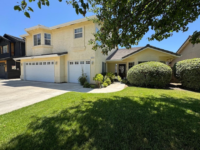 605 W Russell Ave, Visalia, CA 93277 - view of front of home with a garage, stucco siding, driveway, and a front lawn